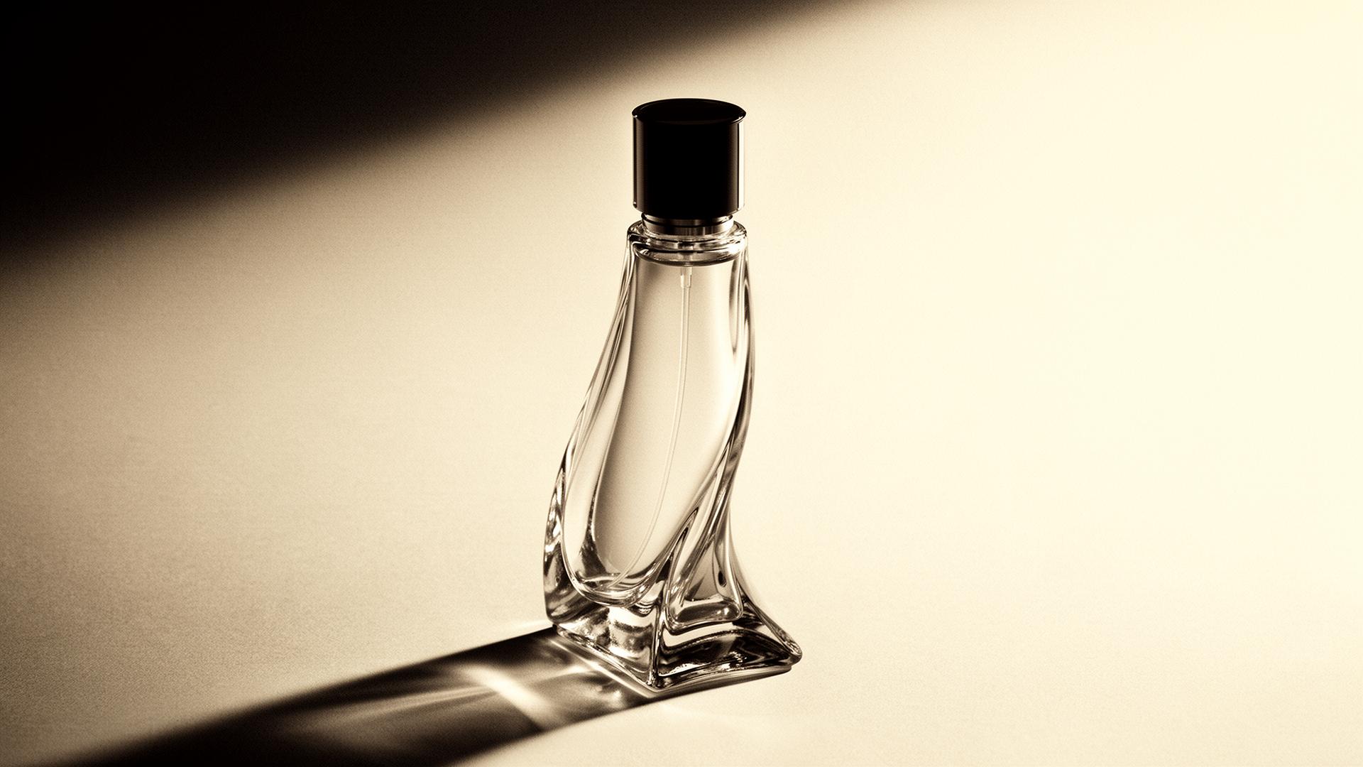 Luxury sculptural glass perfume bottle on cream paper